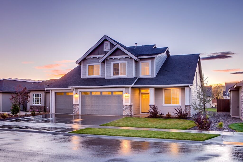 Blue and grey concrete house with attic during twilight